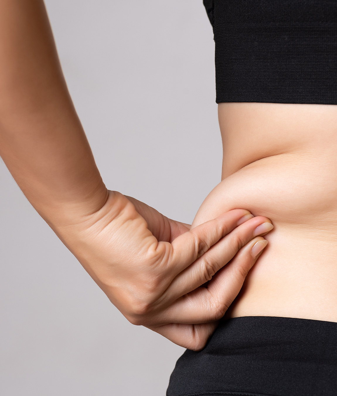 Woman pinching excess fat on her hip